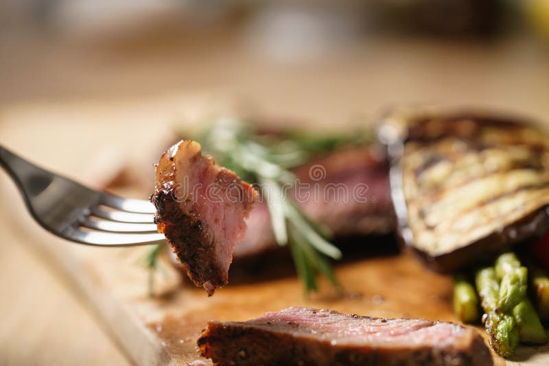 Piece of Medium Rib Eye Steak with Grilled Vegetables Stock Image