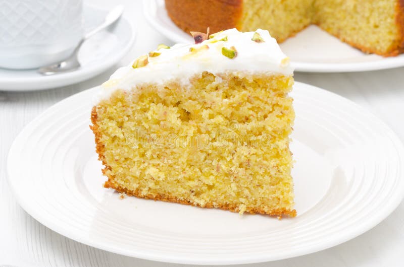 Piece of orange cake with Greek yogurt, honey and pistachios