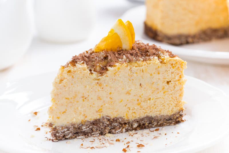 Piece of orange cheesecake on a plate, close-up