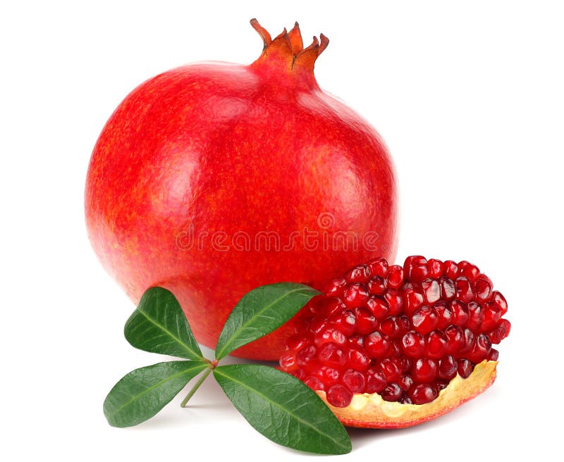 piece of pomegranate with seeds and green leaves isolated on a white background