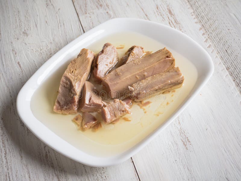 Pieces of Canned Tuna in Olive Oil on a Plate. Stock Photo Image of