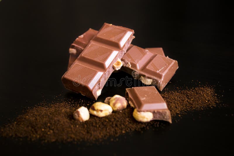 Pieces of Chocolate with Whole Hazelnuts and Ground Coffee Stock Photo