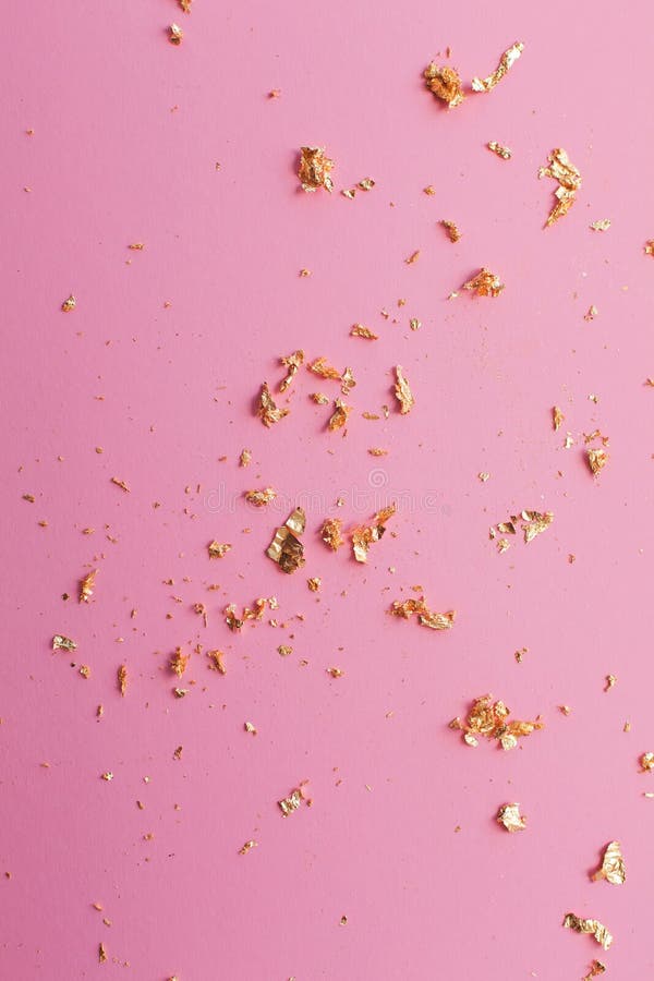 Pieces of Gold on a Pink Bright Background Stock Image - Image of