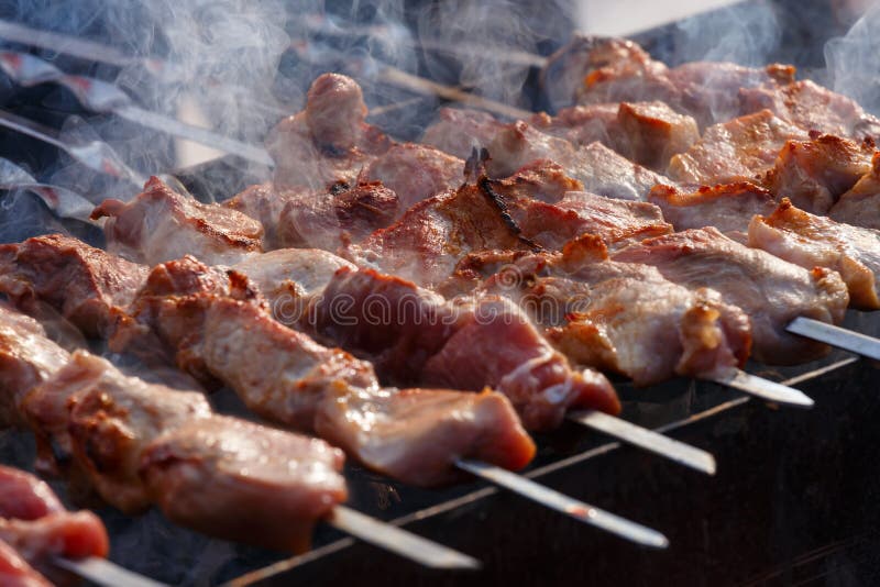 Big Pieces of Meat at Barbecue with White Smoke Over it Stock Image ...