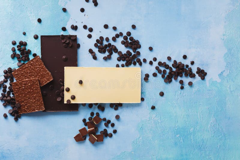 Pieces of Three Different Chocolate Bars and Chocolate Chips Stock