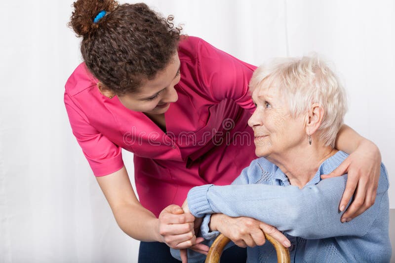 Beautiful nurse taking care of senior woman. Beautiful nurse taking care of senior woman