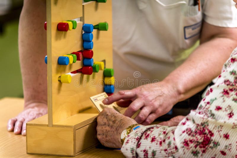 Session of physiotherapy. Nurses, physiotherapists, doctors making simple acts, with children toys, bandage, plaster, splint, pincers, medicines or treadmills, in the rom of the patient. The patient is an elderly person from a public hospital. Session of physiotherapy. Nurses, physiotherapists, doctors making simple acts, with children toys, bandage, plaster, splint, pincers, medicines or treadmills, in the rom of the patient. The patient is an elderly person from a public hospital.