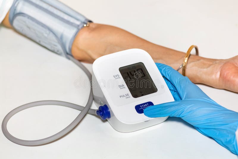 Medical examiner use portable monitoring device to measure blood pressure and heart rate of female patient. Medical examiner use portable monitoring device to measure blood pressure and heart rate of female patient.