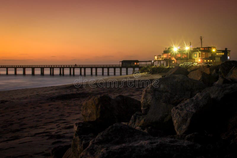 Pier on the Atlantic Ocean in Swakompund, Namibia. Beautiful sunset with a bright sky and soft gentle water