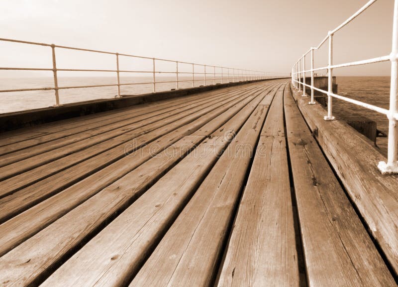 Whitby pier in sepia. Grainy boardwalk. Boardwalk rail stock images, royalty-free photos and pictures
