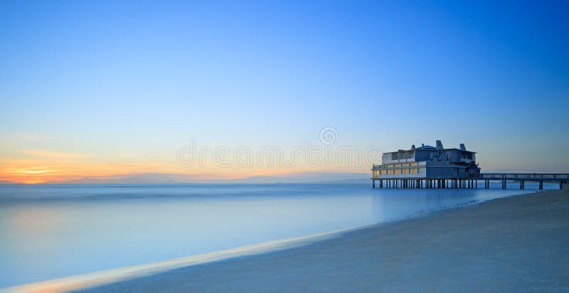 Pier and building on sea and beach. Follonica, Tuscany Italy