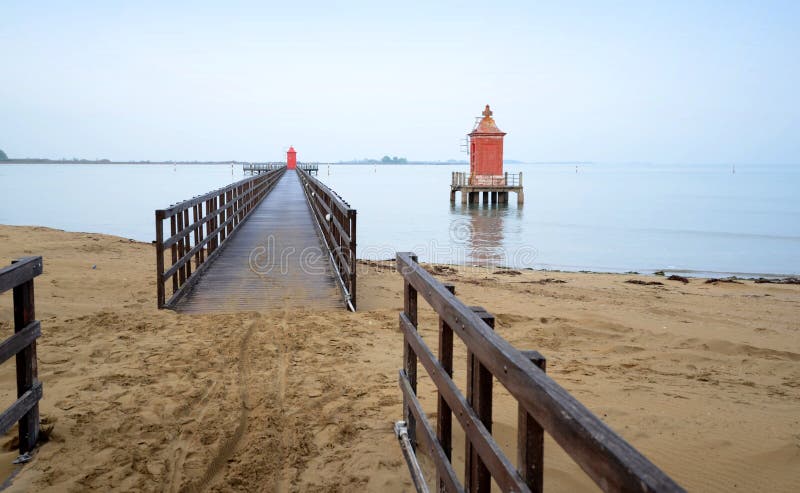 Pier with red tower.Lignano-Italy.