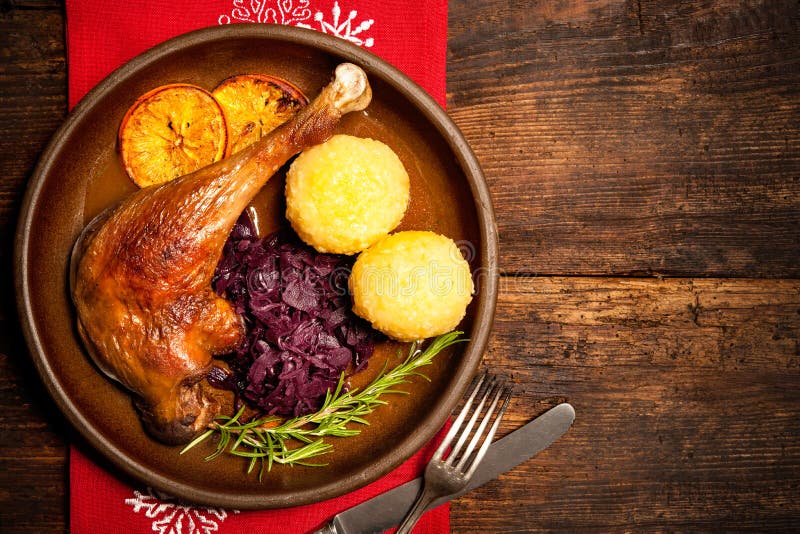 Crusty goose leg with braised red cabbage and dumplings. Cooking at Christmas time. Crusty goose leg with braised red cabbage and dumplings. Cooking at Christmas time
