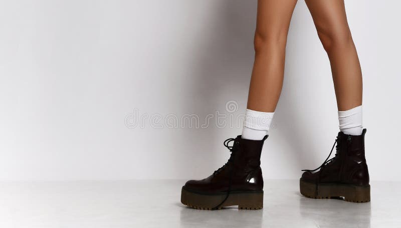 De La Mujer Que Caminan En Calcetines Blancos De Las Botas Negras De Cuero En Pantalones Cortos De Diseñadores De de archivo - Imagen de lujo, corrida: 154375040