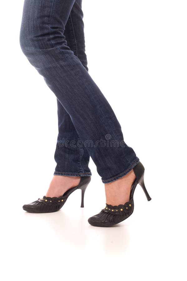 Piernas de la mujer vestidas en pantalones vaqueros fotografía de archivo Piernas de la mujer vestidas en pantalones vaqueros fotografía de archivo
