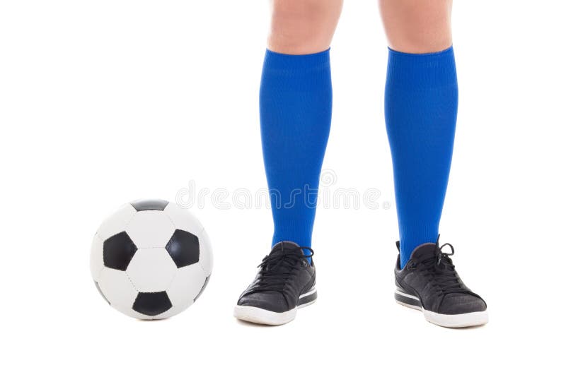 Legs of soccer player in blue socks with ball isolated on white background. Legs of soccer player in blue socks with ball isolated on white background