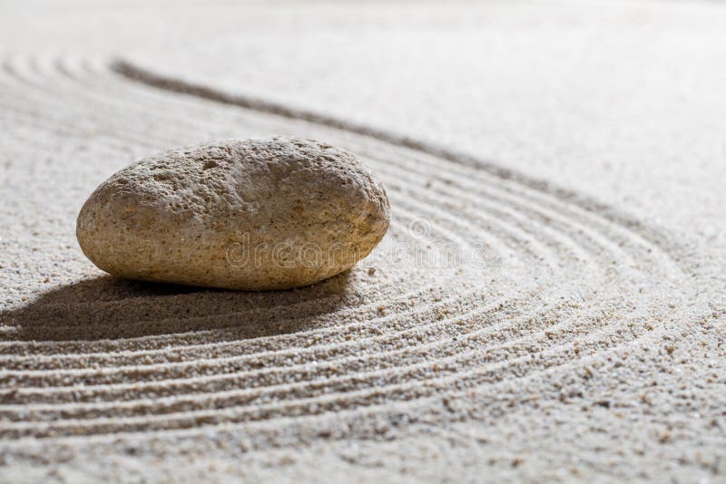 Zen sand still-life - textured stone on sinuous waves for concept of beauty spa or wellness with inner peace, closeup. Zen sand still-life - textured stone on sinuous waves for concept of beauty spa or wellness with inner peace, closeup