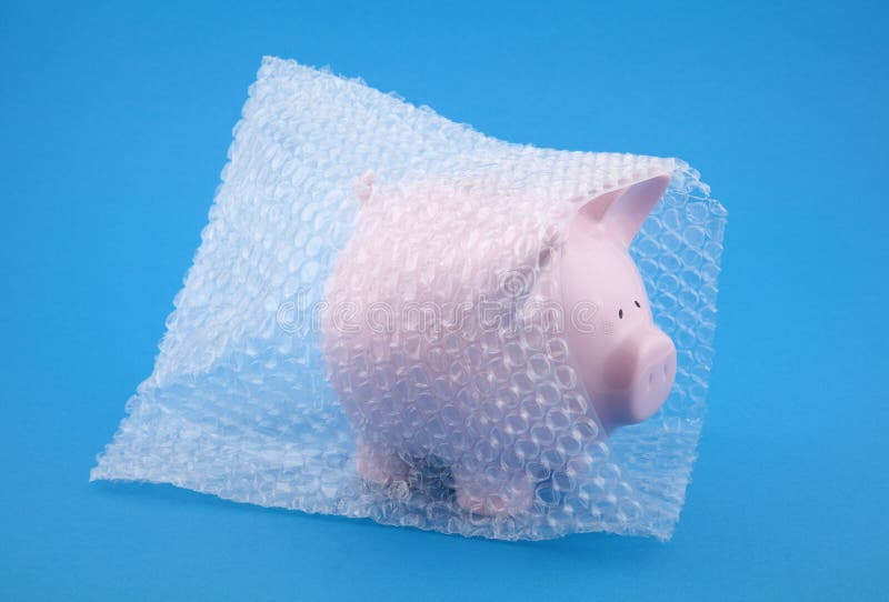 Piggy bank in bubble wrap on blue background