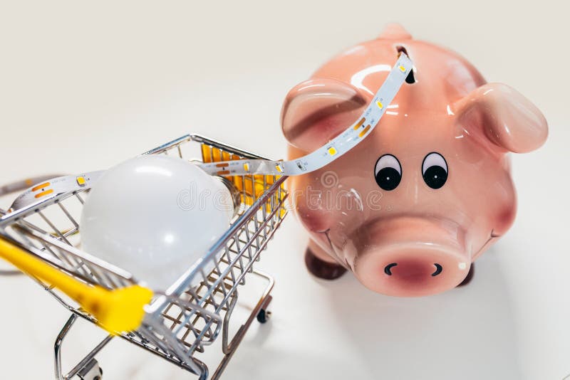 piggy-bank-with-light-bulb-and-led-light-strip-saving-energy-stock