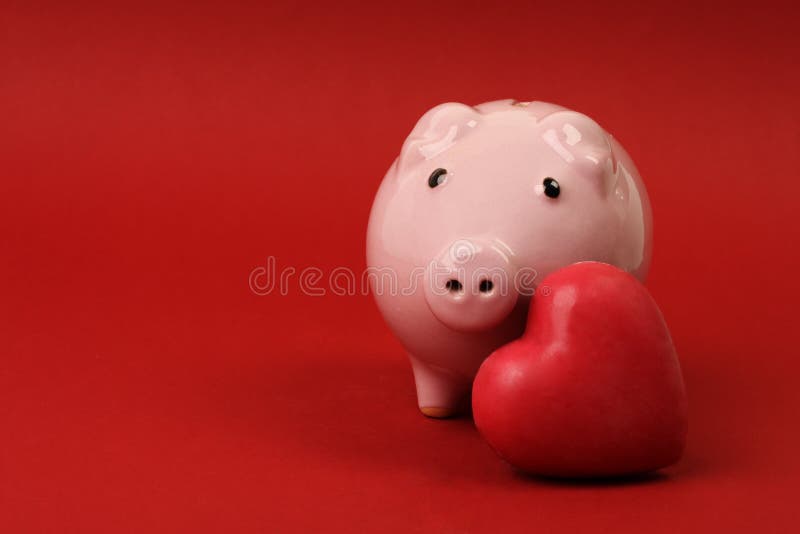 Piggy bank in love with red heart on red background