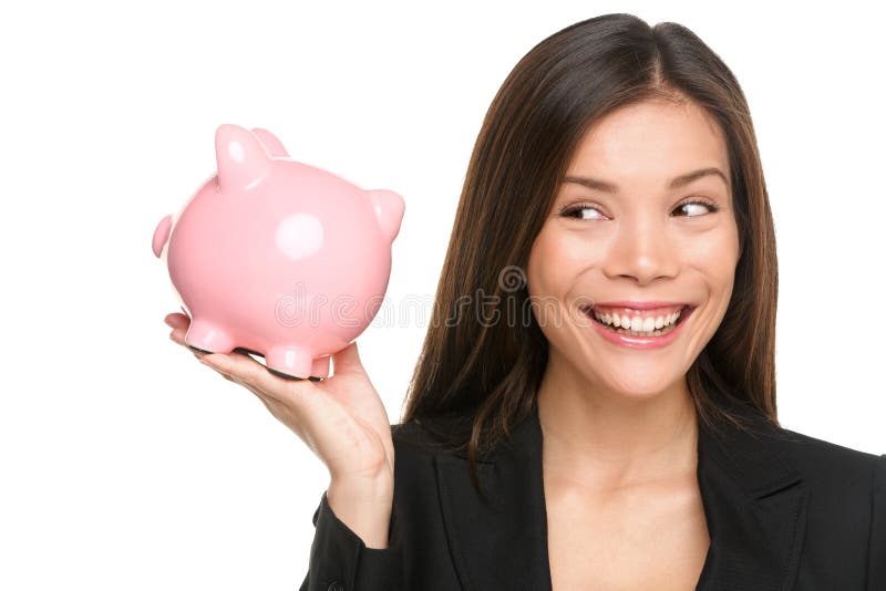 Piggy bank savings woman smiling happy. Female business woman holding pink piggy bank isolated on white background. Multi-ethnic Chinese Asian / Caucasian girl.