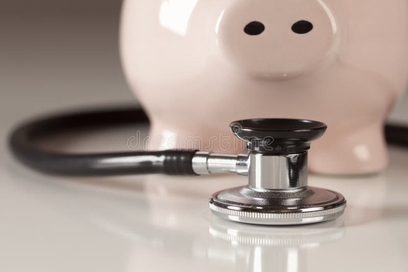 Piggy Bank and Stethoscope with Selective Focus stock photography
