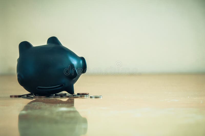 Piggy bank upside down and coins debts and financial problems concept.