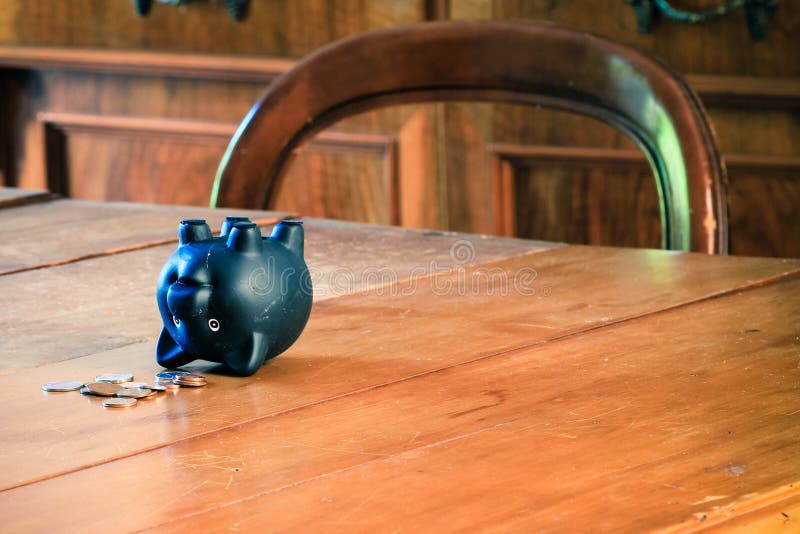 Piggy bank on wooden table.