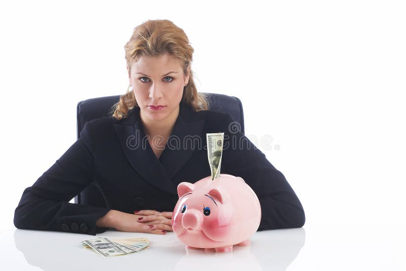 Business lady sitting at her desk in front of a piggy bank with one hundred dollar. Business lady sitting at her desk in front of a piggy bank with one hundred dollar