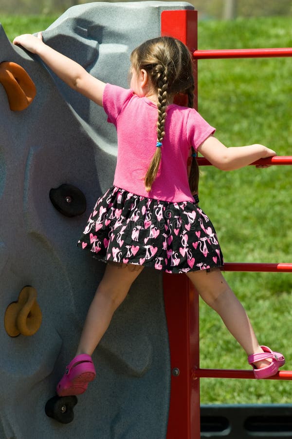 Pigtail Girl Climbing a Rock Wall