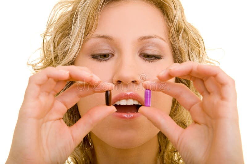 Blonde woman holding two pills in her hands. Blonde woman holding two pills in her hands