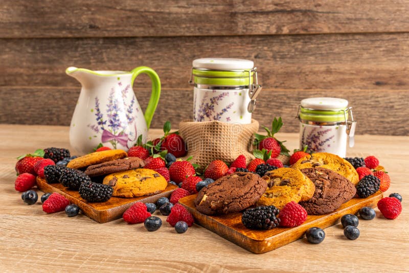 Pila de galletas y de frutas del bosque en tabla de cortar de madera fotografía de archivo libre de regalías Pila de galletas y de frutas del bosque en tabla de cortar de madera fotografía de archivo libre de regalías