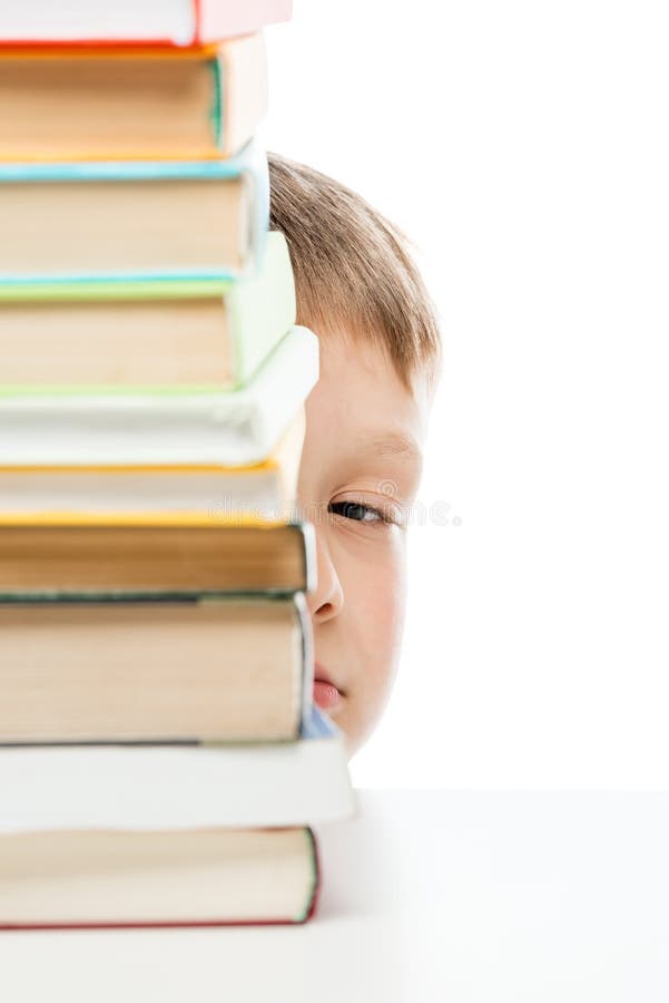 Pila de libros a leer en la tabla y la mirada furtiva hacia fuera de detrás t imagenes de archivo Pila de libros a leer en la tabla y la mirada furtiva hacia fuera de detrás t imagenes de archivo