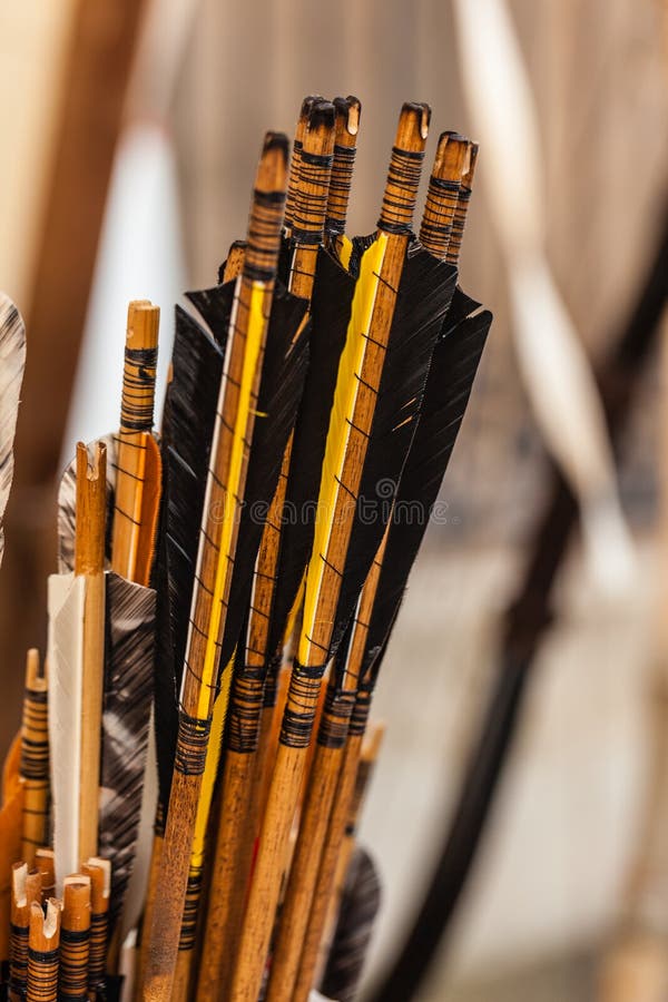 A lot of arrows with tail feathers in a medieval fair. A lot of arrows with tail feathers in a medieval fair