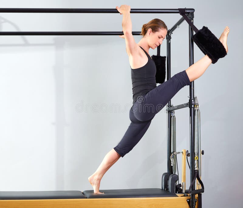 Pilates Woman in Cadillac Split Legs Stretch Exercise Stock Image