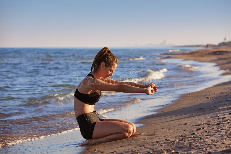 Pilates yoga workout exercise outdoor on beach stock photo Pilates yoga workout exercise outdoor on beach stock photo