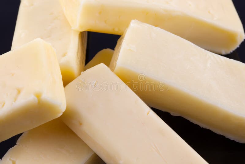 A close up of lots of small cheddar cheese pieces.