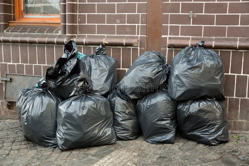 Garbage bags. Waste, black garbage bags plastic pile stack. Lots pile of garbage  bags stack. by KYNA STUDIO. Photo stock - StudioNow