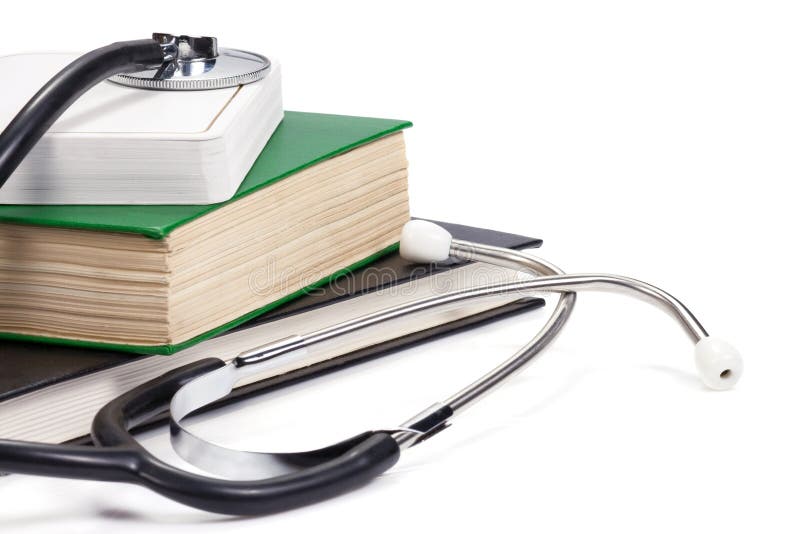 Pile of books and stethoscope isolated on white