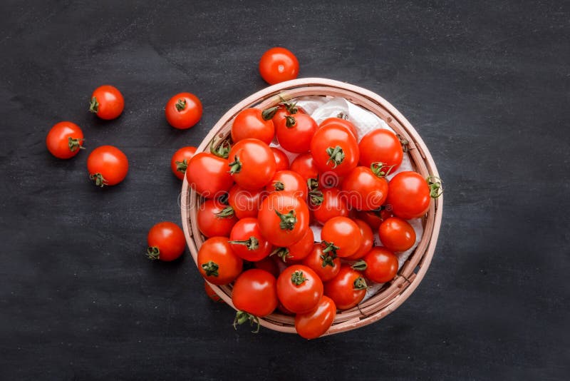 Pile of cherry tomatoes in a rattan basket