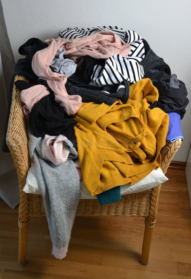 Pile of clothes on a chair stock photo. Image of outfit 179206048