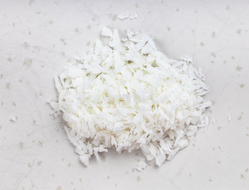 Pile of coconut flakes close up on gray royalty free stock photo