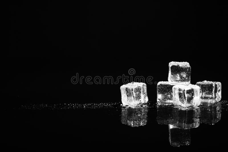 Pile of crystal clear ice cubes on black. Space for text stock images