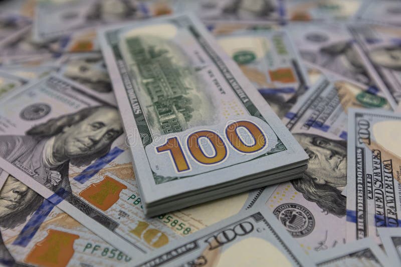 Pile of US 100 dollar banknotes on dollars background for design purpose. Pile of US 100 dollar banknotes on dollars background for design purpose