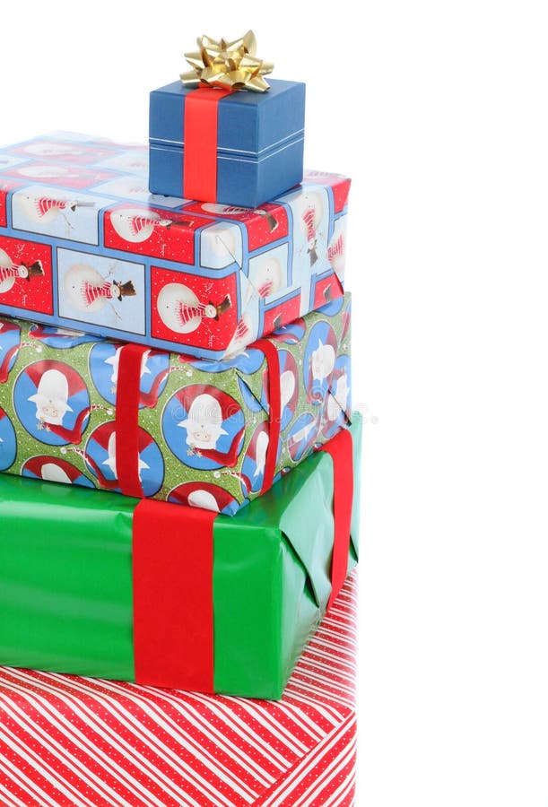 Close up of stack of five wrapped Christmas presents of varying sizes and shapes. Verticla format with copy space at the top and side. Close up of stack of five wrapped Christmas presents of varying sizes and shapes. Verticla format with copy space at the top and side.