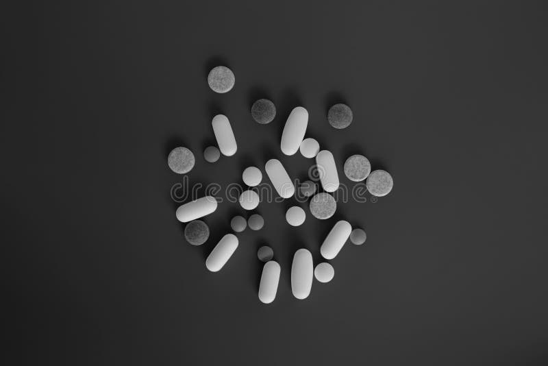Pile of different type tablets on dark background stock image
