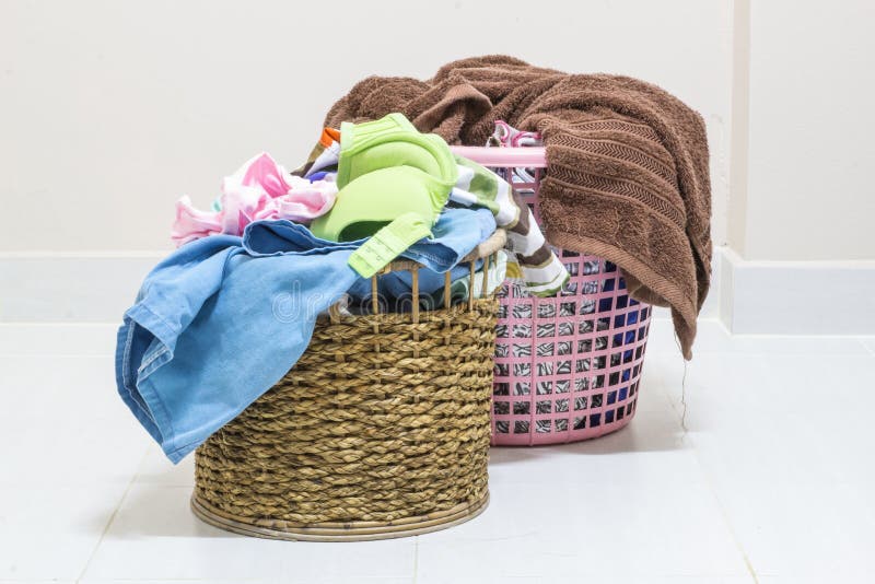 Pile of dirty laundry in a washing basket on a white background