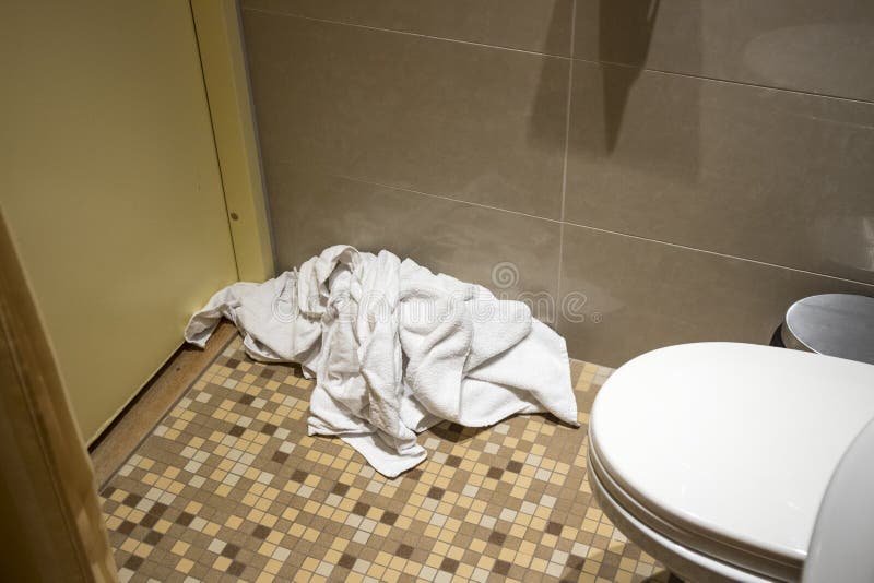 Pile Of Dirty Used Towels On The Hotel Bathroom Floor