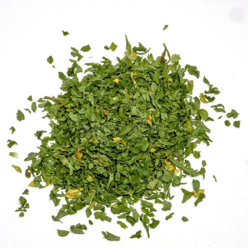 Pile of Dried Parsley Leaves Isolated on White Background Stock Photo
