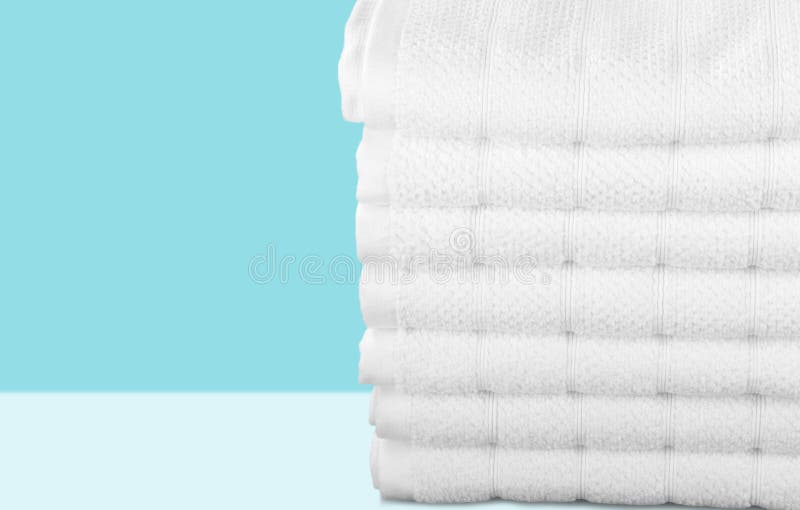 Pile of fluffy towels on light background. Fluffy towels group objects background heap clothing